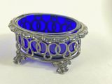 a blue glass bowl sitting on top of a white table