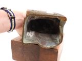 a hand that is holding a piece of wood