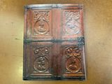 an old wooden door with carvings on it in a room