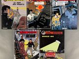 several comics are lined up in a row on a table