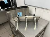 stainless steel table in a commercial kitchen with a microwave on top of it