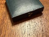 a small black wallet sitting on a wooden table