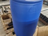 a blue barrel sitting on a pallet in a warehouse