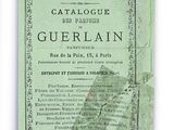 an old book with a green cover sitting on top of a white table