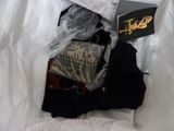 a bag full of clothes and a book on a bed