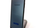 an image of a close up of a cell phone on a stand