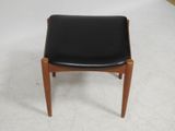 an image of a black leather chair on a white floor