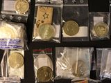 many different types of coins in bags on the table