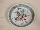 a plate with a flower design on it on a table