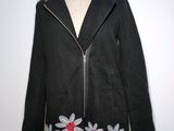an image of a black coat with flowers on it on a mannequin