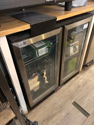 bottles of wine are sitting on top of a counter in a kitchen