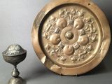 an image of a gold plate with a silver cup next to it