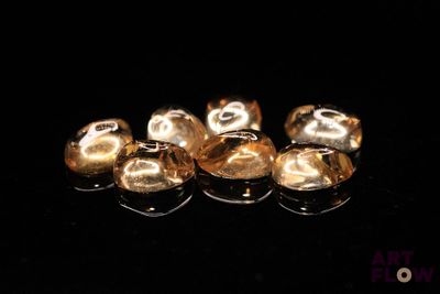 a group of gold bells sitting on a black surface