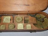 a wooden case with a lot of coins inside of it