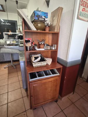 a wooden cabinet with a drawer on top of it