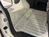 the interior of a white van with the door open and the door open