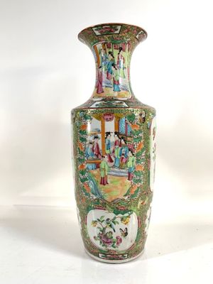 a vase with a painting on it sitting on a table