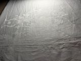 a close up of a bed with a white sheet on it