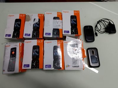 many cell phones that are sitting on a table