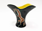 black and yellow vase with a horse design on it
