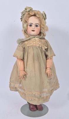 an antique doll with blonde hair wearing a dress and boots