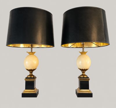 a pair of black and gold table lamps with marble balls