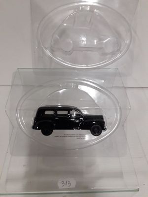 two clear plastic boxes with a black car in them