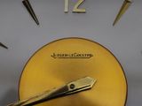 a close up of a clock with a gold face