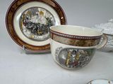 a cup and saucer sitting on a table next to a plate