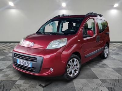 the small red van is parked in a large room