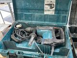 a blue tool box with a drill and other tools in it