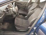 the interior of a car with the door open and the passenger seat down