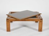 a small wooden table with a tile on top of it