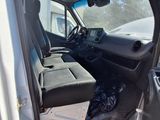the interior of a truck with the door open and the driver ' s seat down