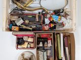 a wooden box filled with assorted items on a table