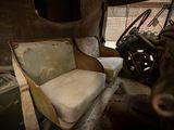 a seat in the back of a truck with a seat cushion