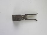 a small metal object that is on a white surface