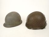 two helmets are sitting next to each other on a white surface