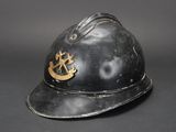 an old black fireman ' s helmet with a gold emblem on it