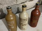 three old bottles sitting next to each other on a table