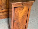un petit meuble en bois muni d'une porte et d'un tiroir