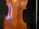 a close up of a violin with a bow on a black background