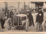 an old photo of a group of men standing around a car