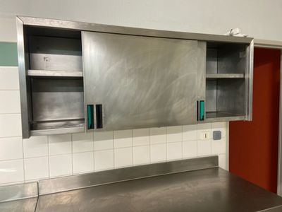a stainless steel counter top in a kitchen with a red door