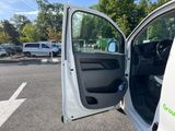 a white van with the door open in a parking lot