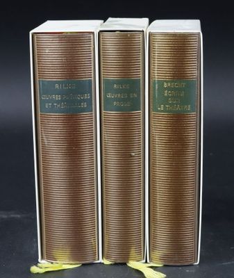 three books sitting on top of each other on a black surface