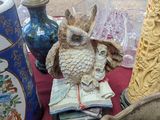a table with vases and a statue of an owl on it