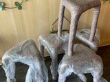 three chairs and a stool made out of plastic wrap