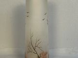 a glass vase with a picture of a tree and birds on it