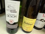 several bottles of wine are lined up on a counter top